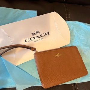 New brown/tan/camel coach wristlet.